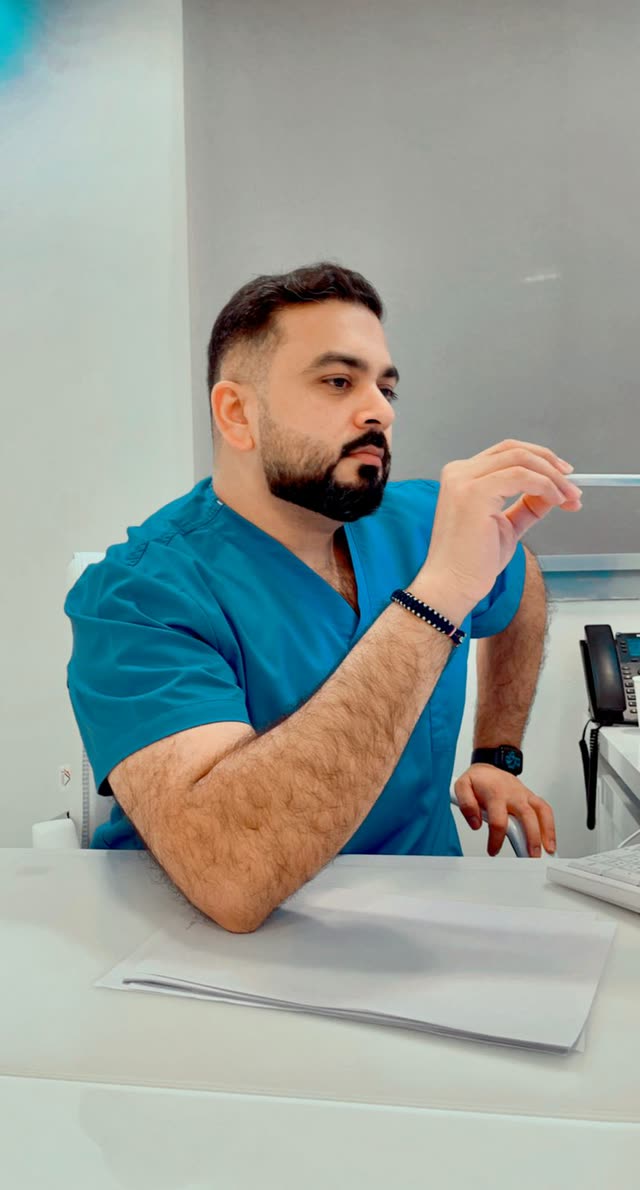 Dr. Usman in scrubs at the clinic