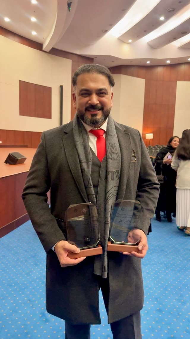 Dr. Usman receiving an award